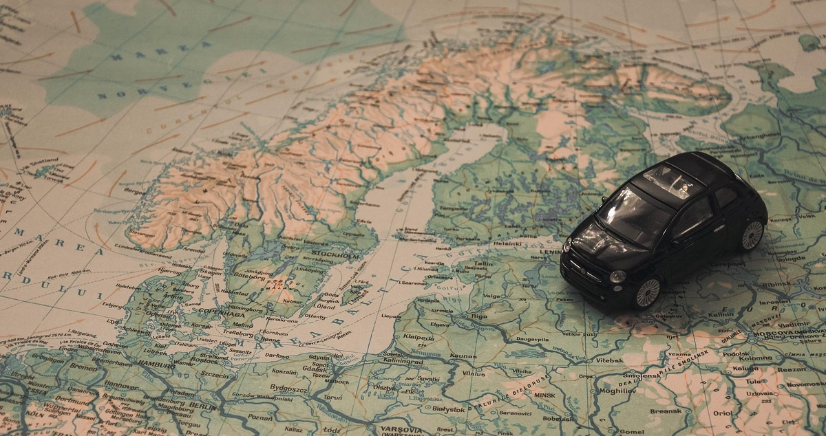Toy car placed on a map of Europe, symbolizing road travel across EU countries