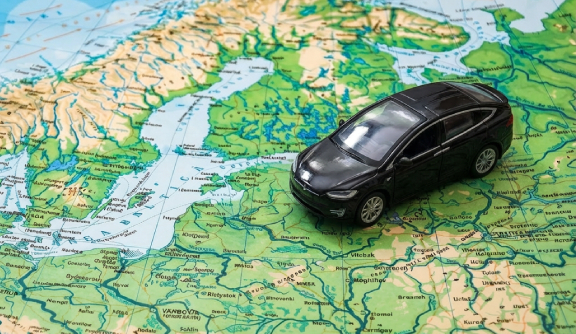 Toy car placed on a map of Europe, symbolizing road travel across EU countries