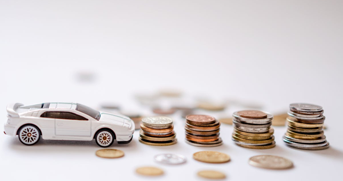 Sports Car Toy Beside the Pile of Coins