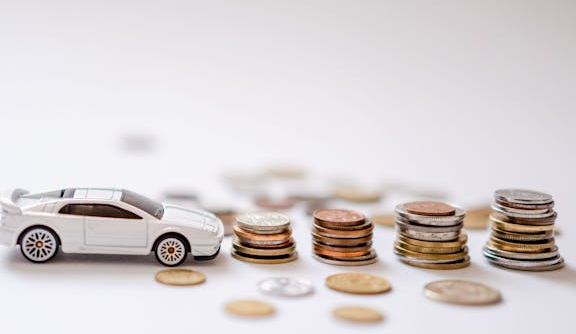 Sports Car Toy Beside the Pile of Coins